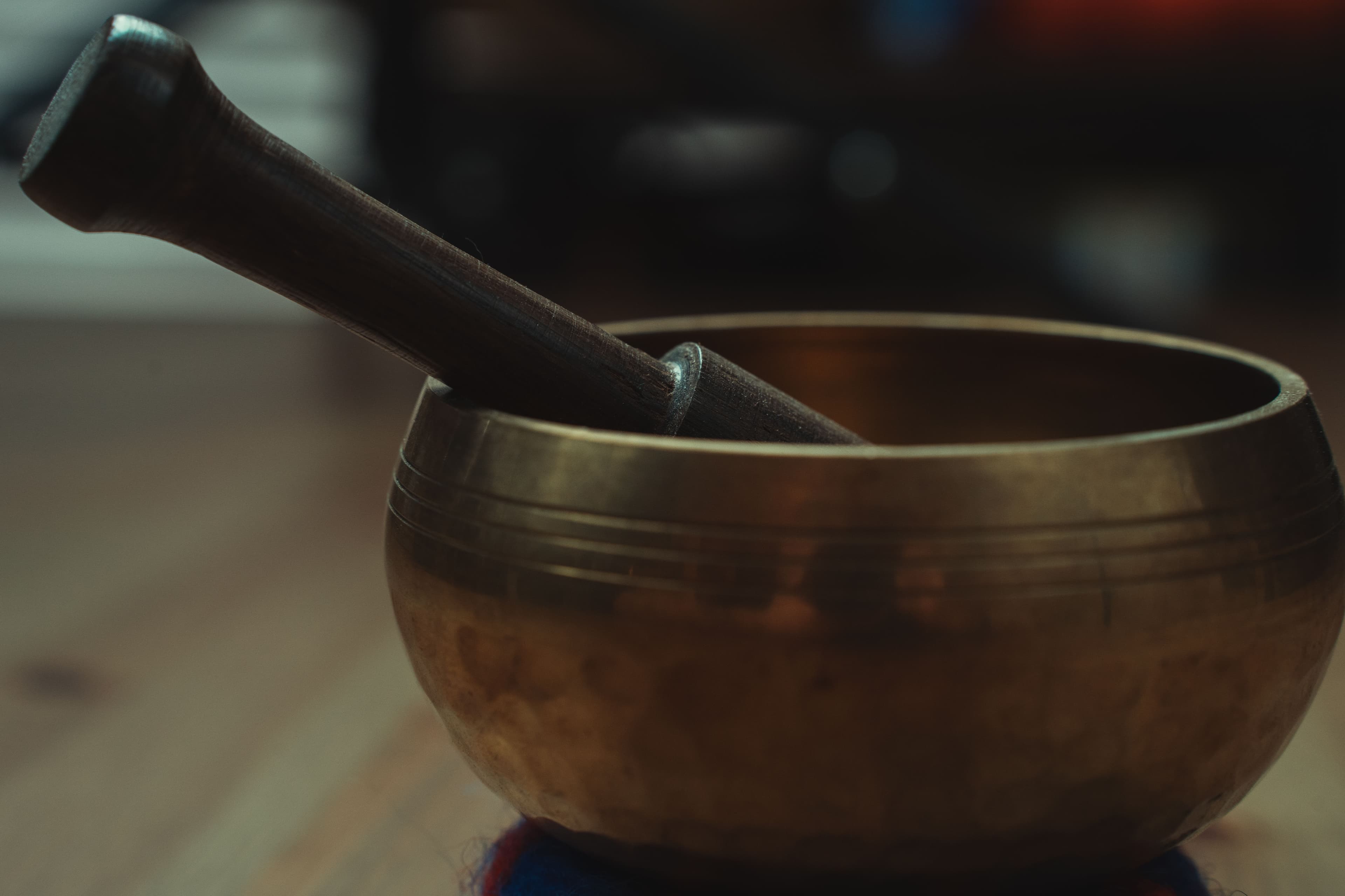 Close-up of a bronze Tibetan singing bowl and mallet