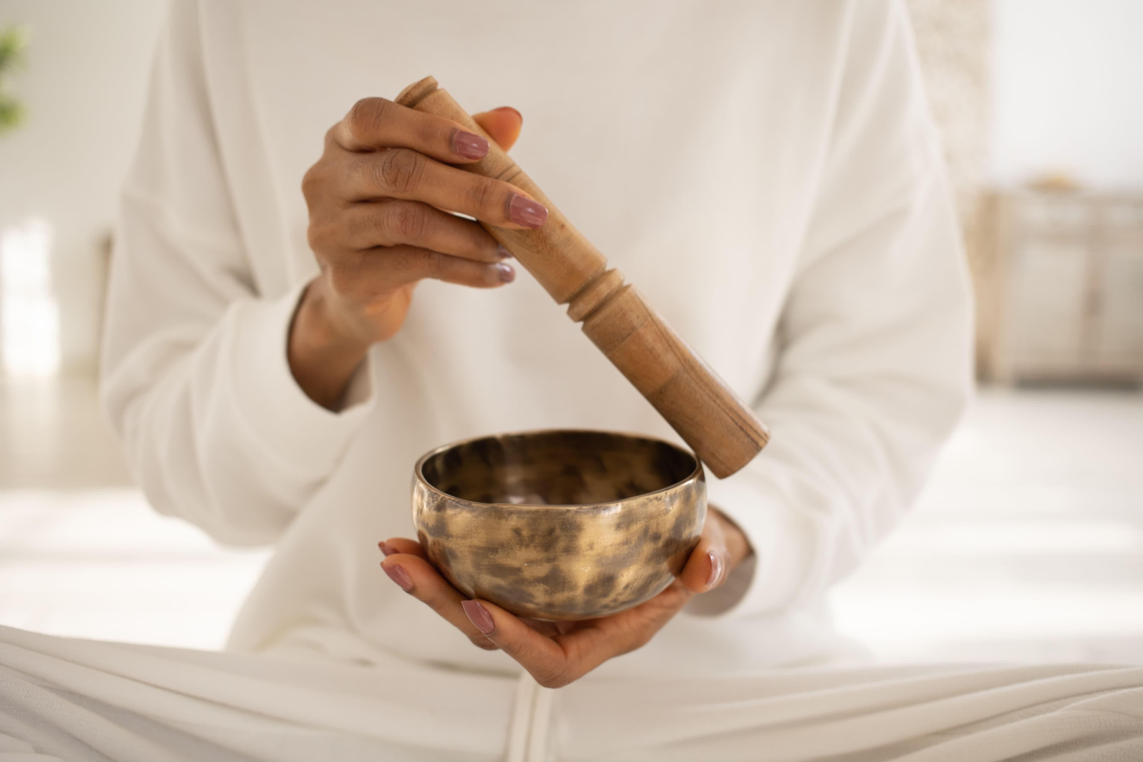 Close-up of a person playing a Tibetan singing bowl